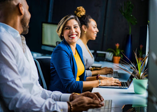 Business owner working at a computer and smiling